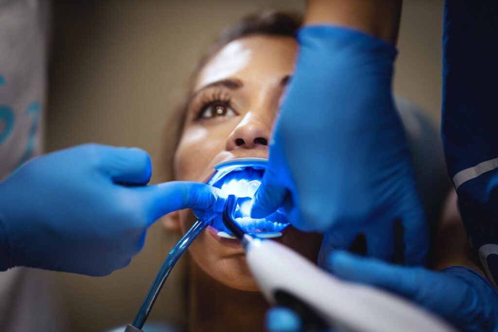 Beautiful Young Woman Is Dentist She Sits Dentist S Chair Dentist Sets Braces Her Teeth Putting Aesthetic Self Aligning Lingual Locks With Infrared Lamp 360066 20923