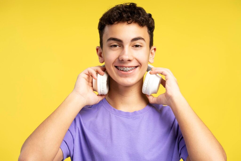 Portrait Handsome Smiling Boy With Braces Wearing Headphones Listening Music 695242 7608 Portrait Handsome Smiling Boy With Braces Wearing Headphones Listening Music 695242 7608