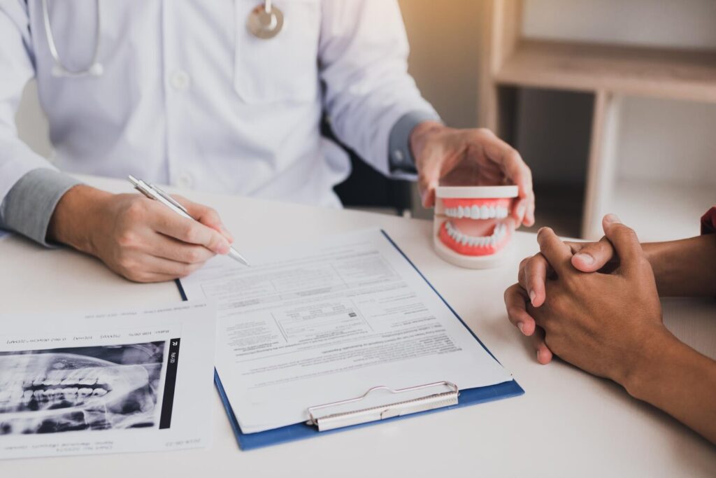 Midsection Dentist With Patient Writing Form Table Clinic 1048944 23969390 Midsection Dentist With Patient Writing Form Table Clinic 1048944 23969390